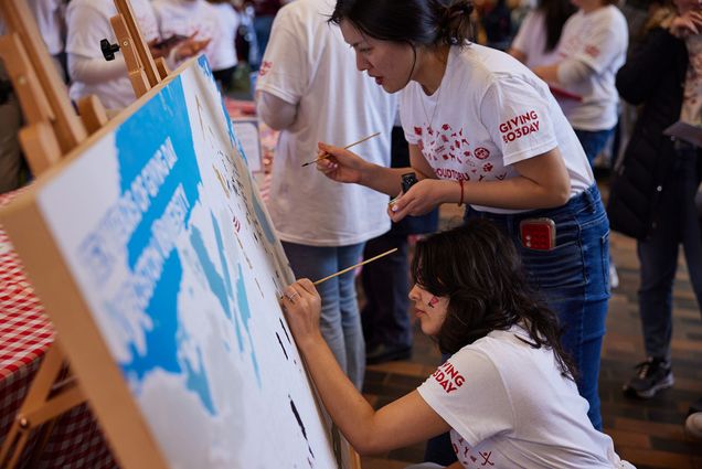 Photo: BU students painting a mural of campus at the George Sherman Union