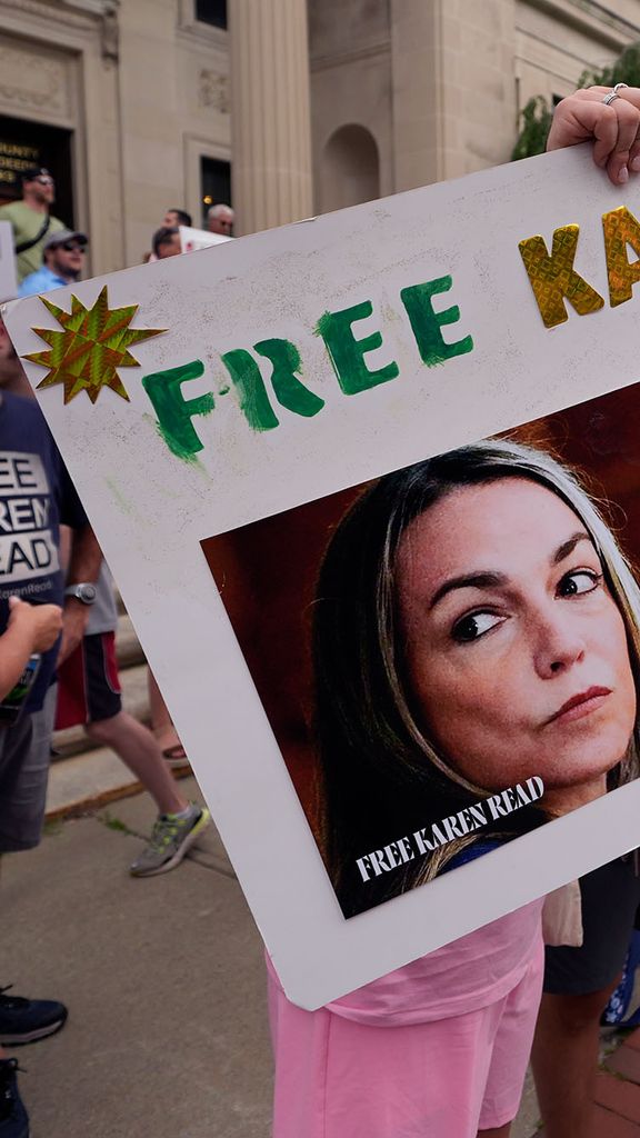 Photo: A group of people holding signs in support of Karen Read. Prominent poster says "Free Karen Read" with a picture of a white woman
