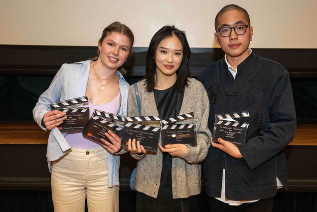 Photo: Three young individuals pose for a portrait holding their awards.