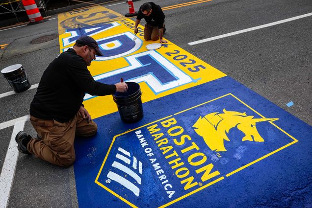 Photo: Workers painting the 2025 Boston Marathon starting line, which features blue and gold coloring