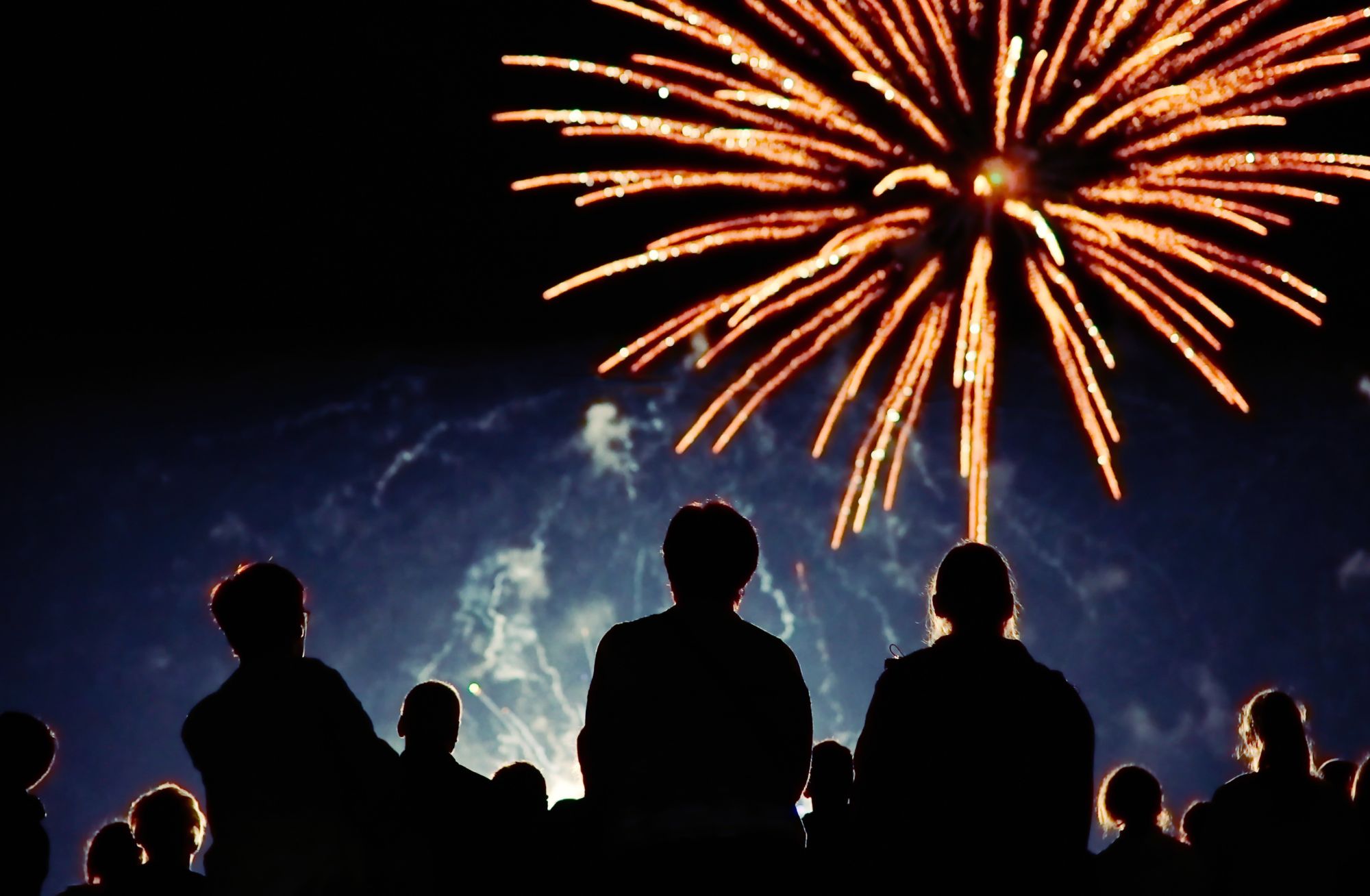 Fireworks display with people watching.