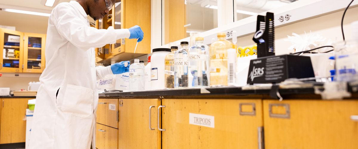 Man in white lab coat in lab