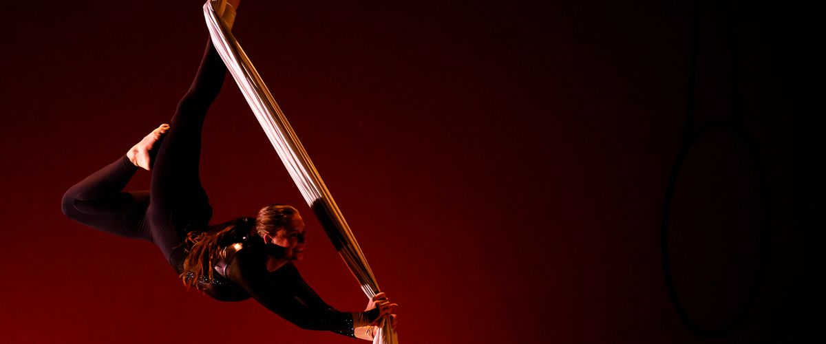Dancer on a dark background using silks