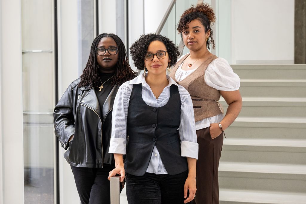 Photo: Three women posing for a photo in front of a set of stairs