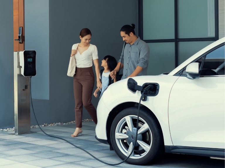 An advertisement of an electric car with people holding hands.