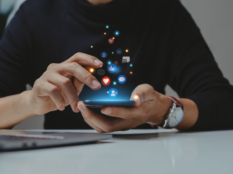Person scrolling online using a smartphone.
