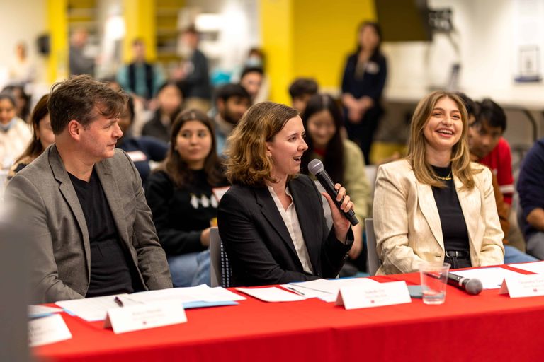 Judges at pitch and pizza smiling giving feedback