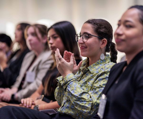 Students applauding in an audience