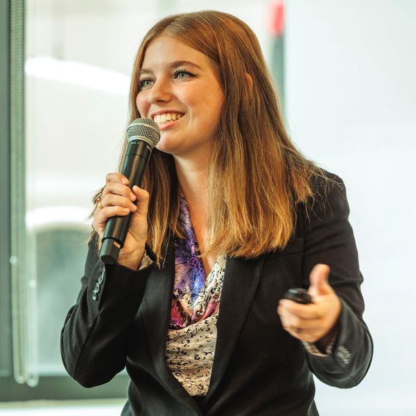 Hannah Martin presenting with microphone