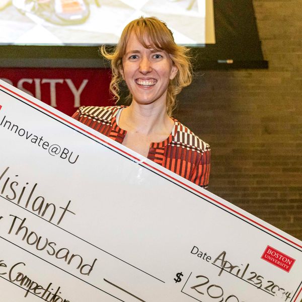 JOrdan smiling holding a large check