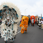 A group of Mardi Gras Indians, that includes David Montana in white, march near the overpass during carnival. In the early twentieth century, African Americans could not participate in the city’s all-white Carnival parades; instead, they asserted a view of history that emphasized historical interactions between Native Americans and people of African descent. As counter-monuments, Mardi Gras Indians portrayed an Afro-centric vision of history that directly confronted the myth of white supremacy. (Photograph by C. Becker).