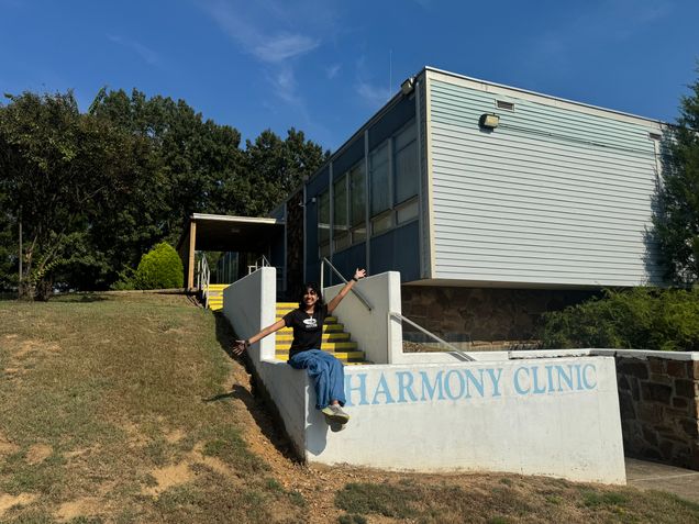 KHC Student (Shreeya Khullar) sits outside the Harmony Health Clinic in Little Rock, Arkansas