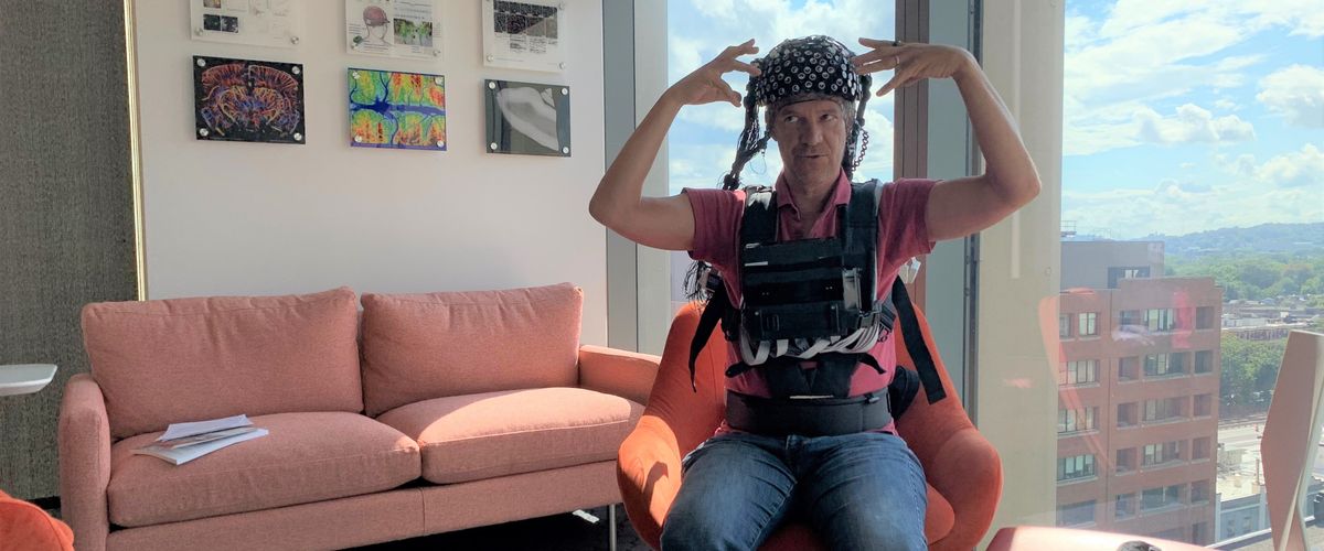 David Boas wearing a brain imaging device on his chest and head