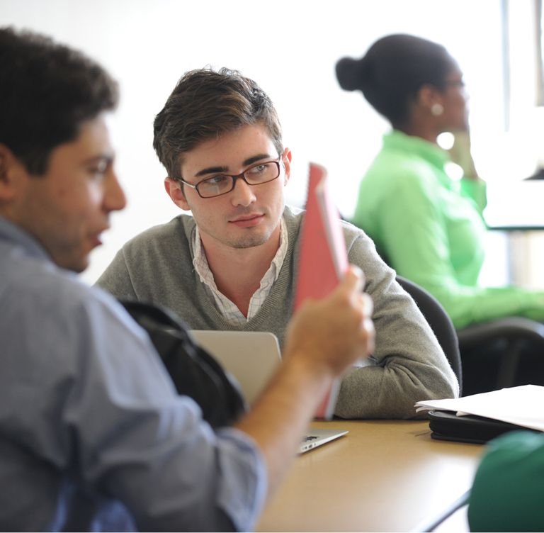 Photo of male student at table with laptop