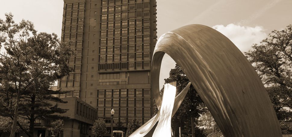 A sepia-toned photo of the BU Law tower with the BU beach and the whale sculpture in the foreground