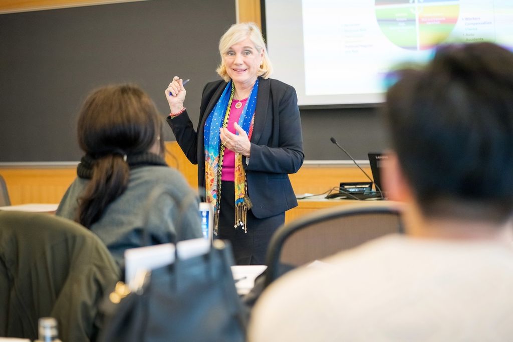Virginia Greiman leading a classroom of students.