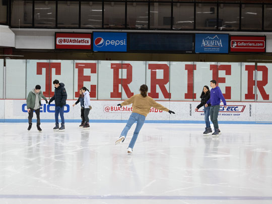 Students enjoy a range of activities at BU MET. In this image see students ice skating with their classmates on a group outting.