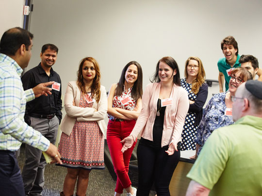 A group of conference participants conversing at the 2018 Project Management in Practice (PMIP) conference