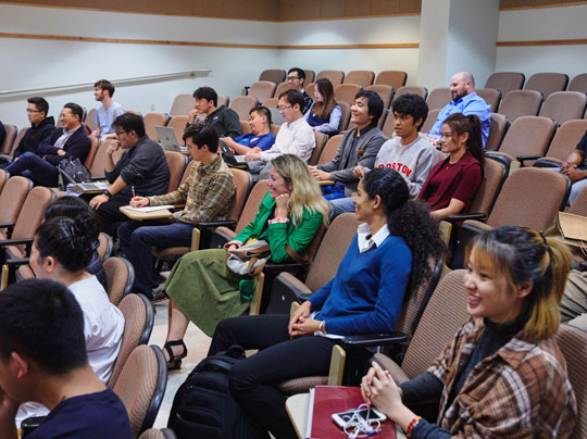 A group of happy students seated in a lecture hall
