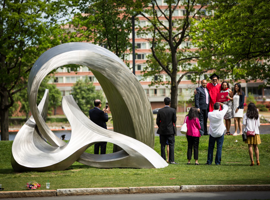 Information for Admitted Students. An image of students on the BU Beach near a metal sculpture