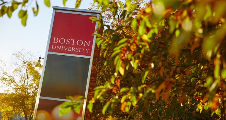 Red Boston University sign in leaves