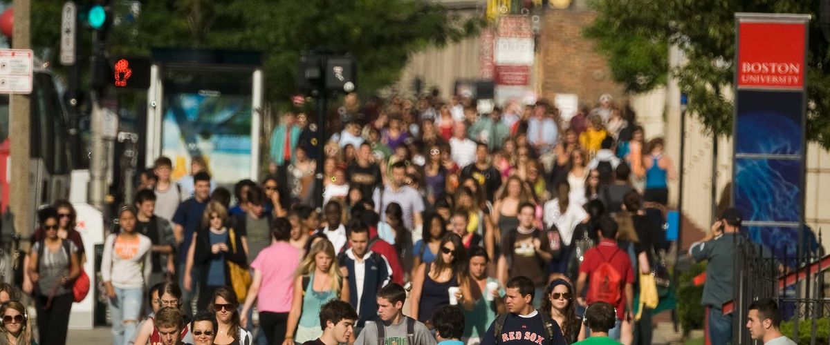 Boston University students walking on Commonwealth Avenue in sunny weather