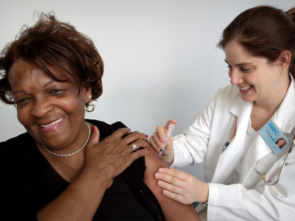 Women recieving shot in arm