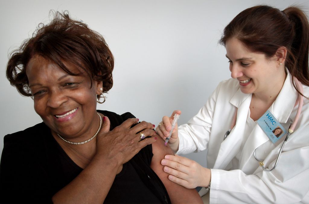 Woman recieving shot in arm
