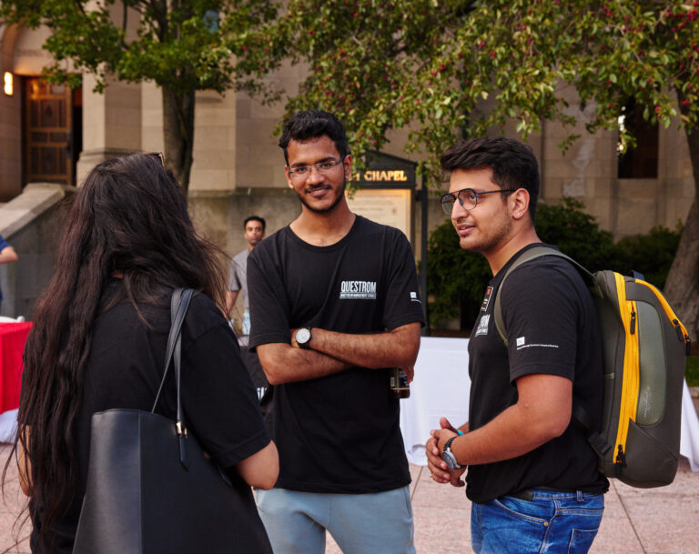 Students with backpacks a conversation on campus