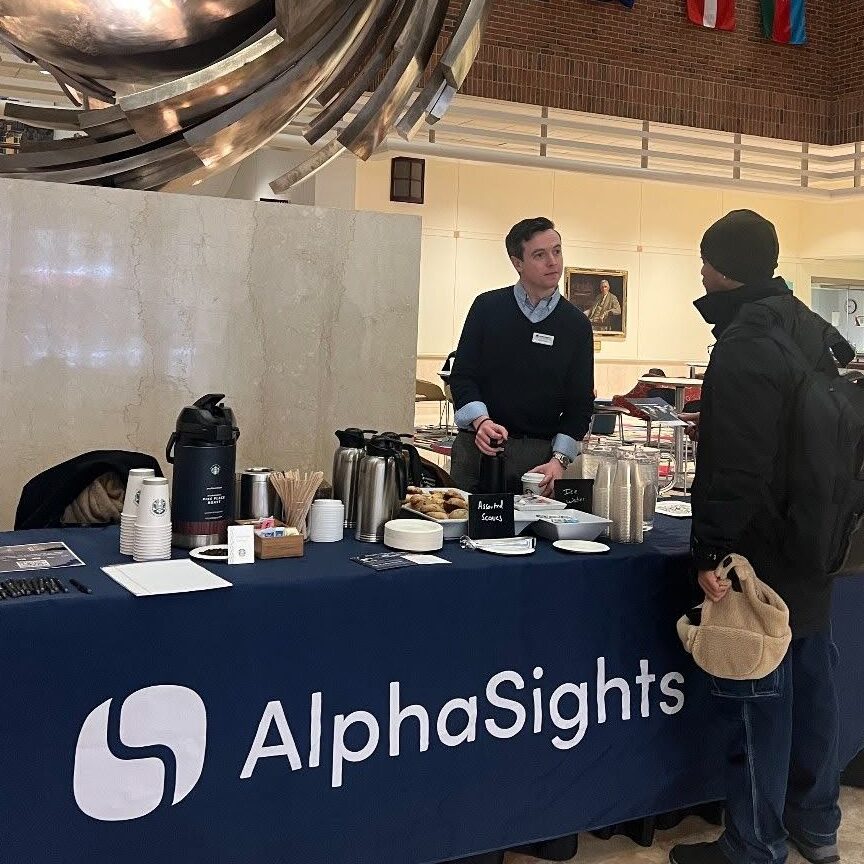 A student speaks with an employer at a company pop up in the atrium
