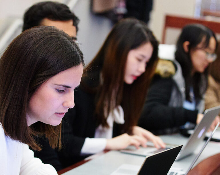 Classroom of students looking intently at their laptops