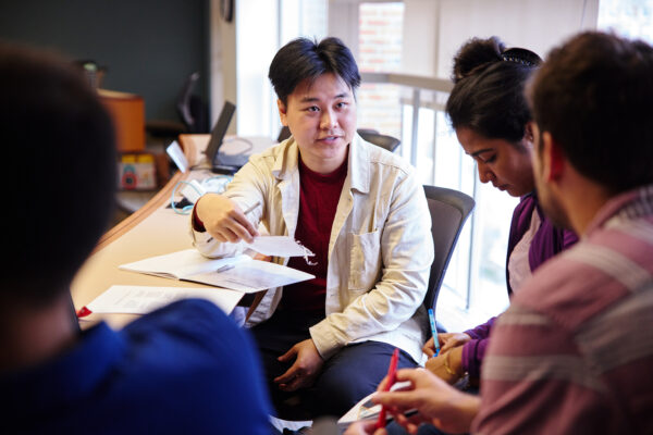 Students sitting around a table in discussion