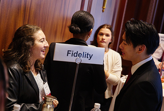 Student speaking with a potential employer at a career fair