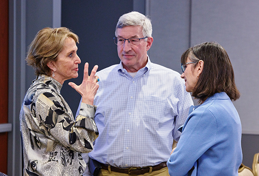 Three marketing professors having a discussion