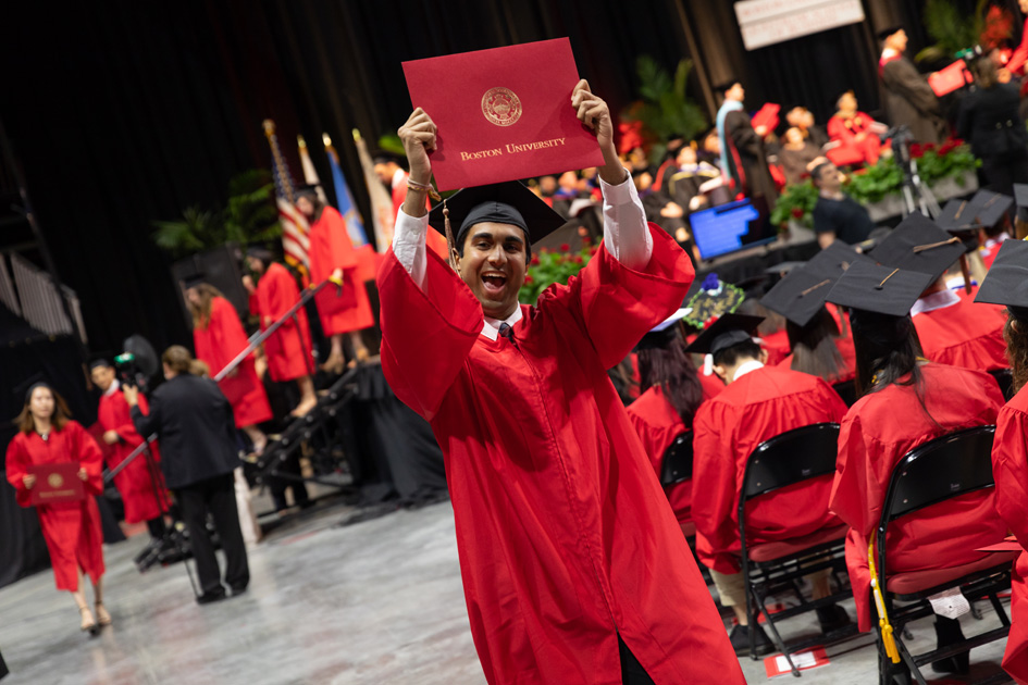 Student celebrating with diploma at Graduation