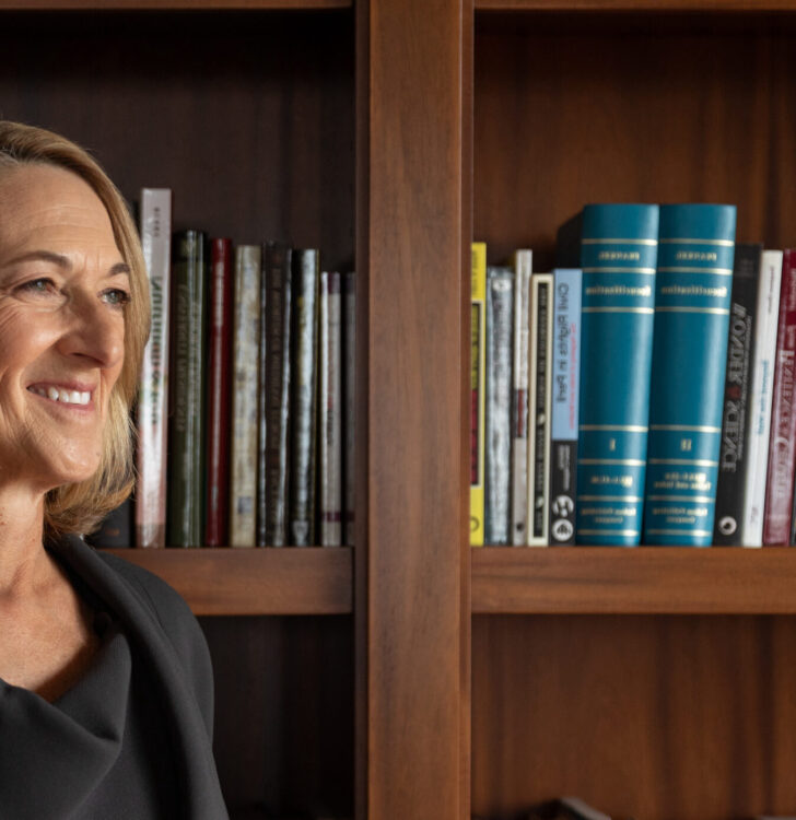 Dean Susan Fournier standing in front of bookshelves