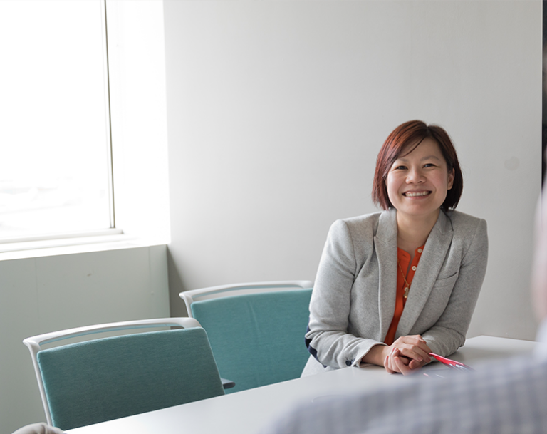 Executive at conference table smiling at camera
