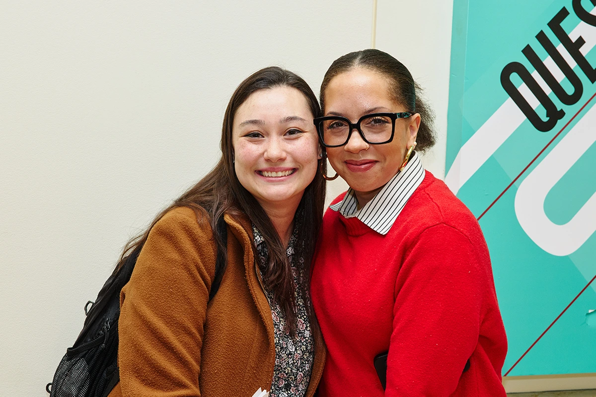 Student and staff member post for a photo