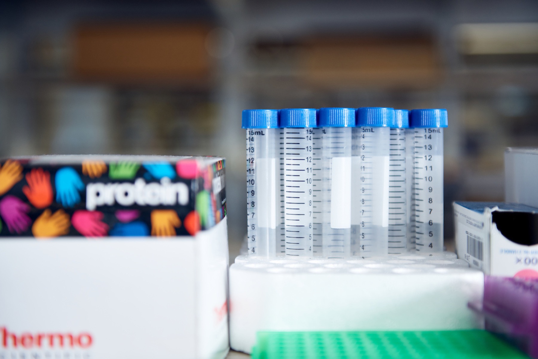 Test tubes and a supply box sit on a lab bench