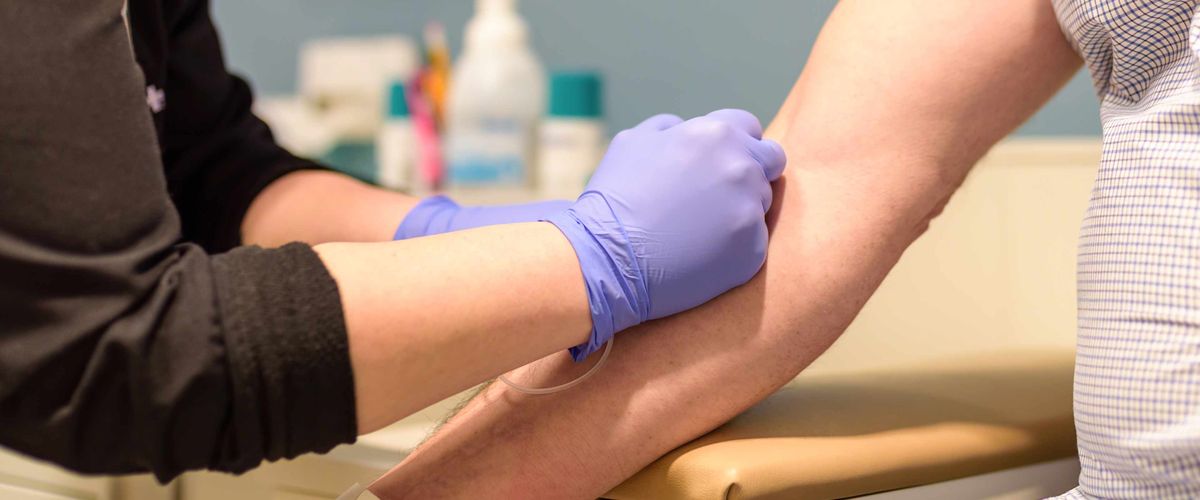 Health professional taking blood