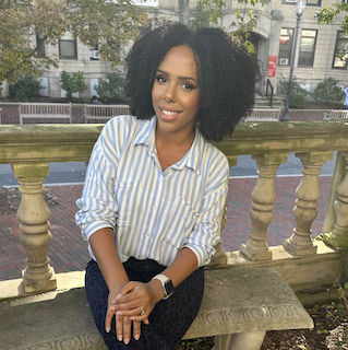 Yamelly Pena posing for photo on bench