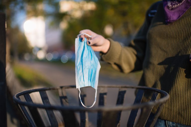 Person throwing masks away