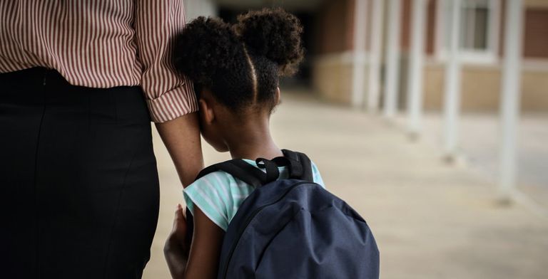 child holding parent's hand
