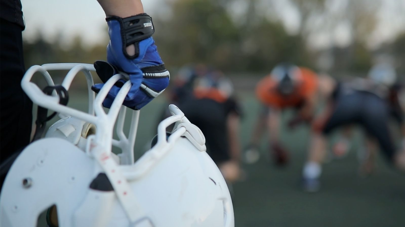 Football player holding helmet