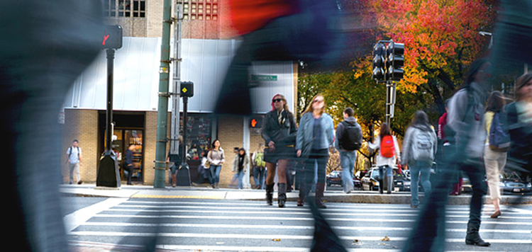 Street level view of people crossing the street near Warren Towers