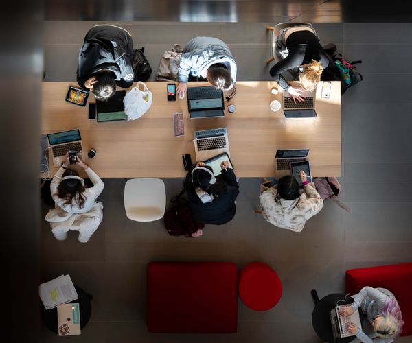 View from above of students studying at table
