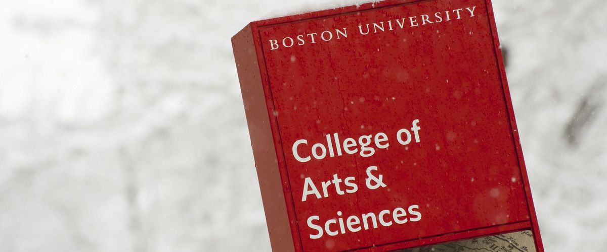 A sign that says "College of Arts & Sciences" and it is snowing