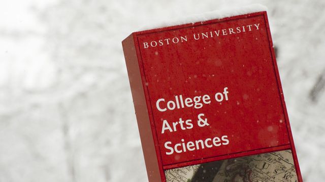 A sign that says "College of Arts & Sciences" and it is snowing
