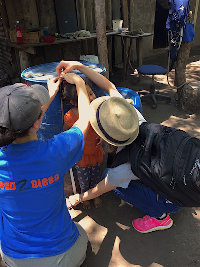SPH students measure a child in Quezalguaque as part of their nutrition research.