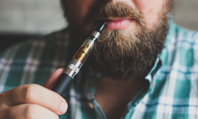 young man with the electronic cigarette in a shirt